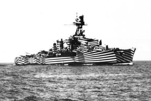 A battle ship in gaily painted stripes.