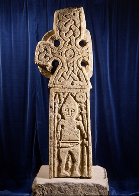 Middleton Cross depicting a Viking warrior surrounded by his weapons