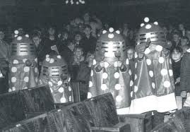 Children in vintage toy Dalek costumes